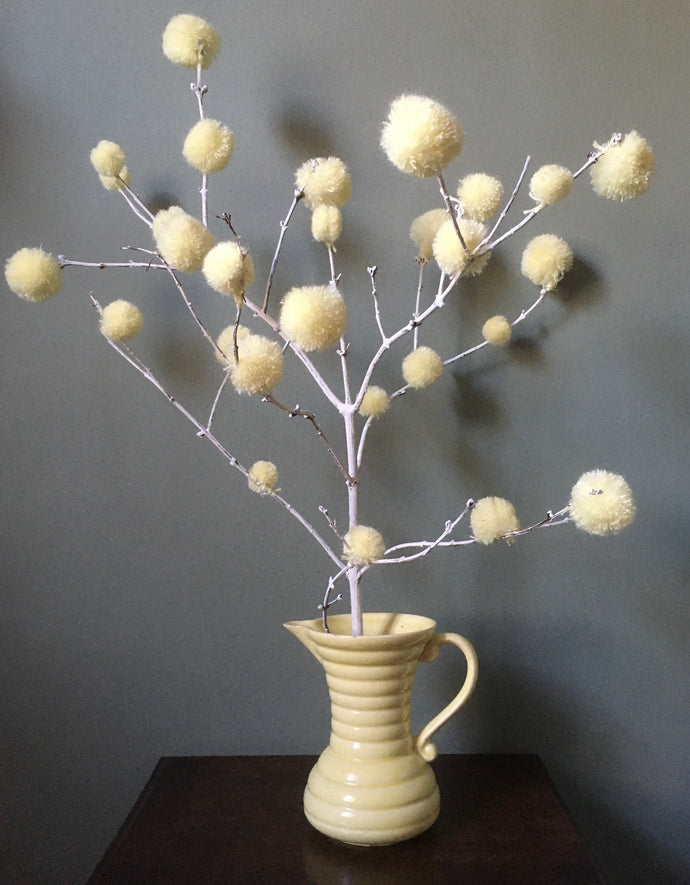Pompoms can be Eastery too! These pale lemon pompoms are attached to a branch from the garden, to make an Eastery decoration..