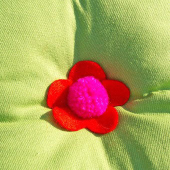 Before you stitch your pompom, why not thread through piece of felt which has been cut into a flower shape. The pompom becomes the centre!