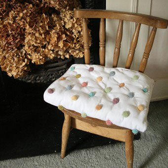 Gorgeous quilted blanket which has been made from felted tapestry wool pompoms.