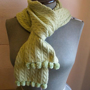Attach matching pompoms to your hand knitted (or bought) scarf for a subtle look.