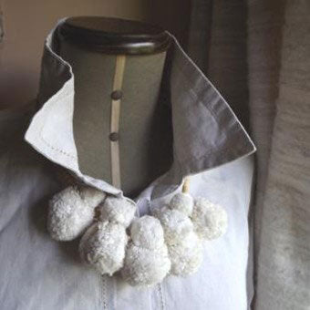 Craft cotton pompom necklace. Our instructions give you tips on how to make them extra fluffy.