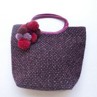 Spruce up a bag from last season by bunching together a mixed selection of colourful pompoms.