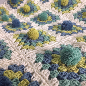 The pattern for this gorgeous cot blanket can be found in our project book. The book, which contains 25 projects to make with a Multipom, is available to buy online from our shop page.