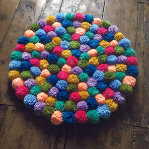 This pompom rug has been made with Multipom's Rug Making Kit, a great way to brighten up any room.