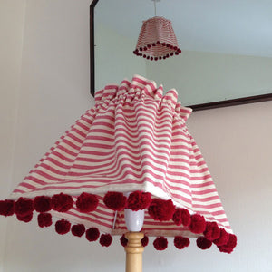 Pompom the edge of any lampshade with tiny pompoms can be a really quick makeover project.