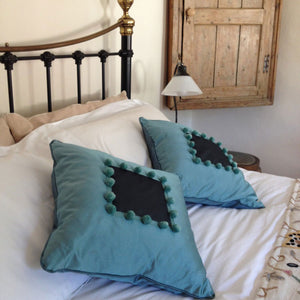Handmade Cushions.  Pompoms make a great and simple stylish addition to cushions. Stitch the pompoms to secure using the ties created in the making process.