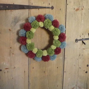 Mix and match your left over wools to make a seasonal wreath. These are tied to a wire florists' frame which has been wrapped with fabric first. A simple and effective solution to decorate and personalise any room.