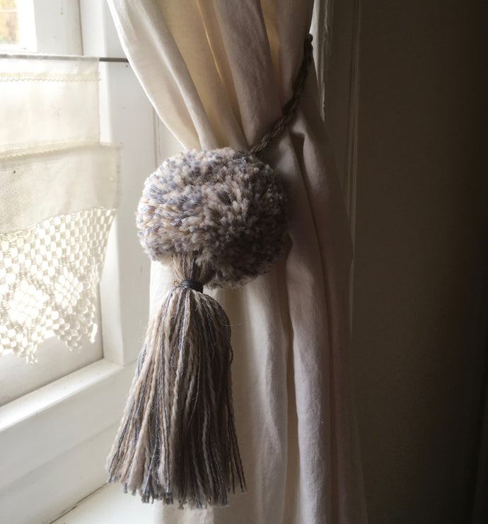 A pair of matching tie backs to enhance a drape. Tassels can also be made on a Multipom.