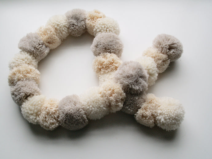 A gorgeous pompom scarf. Making 4 pompoms at a time, thread them densly onto a cord to make this snuggly fluffy scarf.