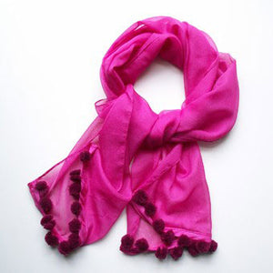 Pretty in pink. Make a plain pink scarf stand out with these mini handmade pompoms.